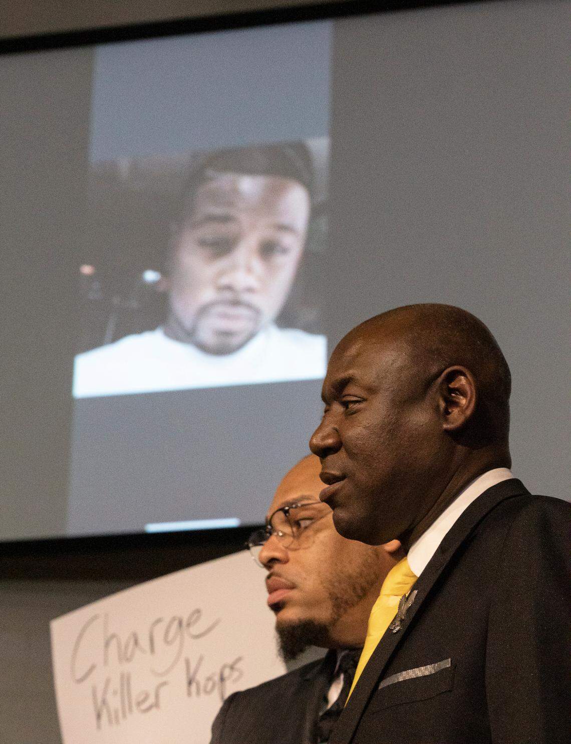 Attorney Ben Crump, right, stands in front of a photo of Darryl “Tyree” Williams shown on a projector during a press conference on Thursday, Feb. 16, 2023, at Mount Peace Baptist Church in Raleigh, N.C. Crump called for charges against Raleigh police officers in the death of Darryl Williams, who died in police custody on Jan. 17.