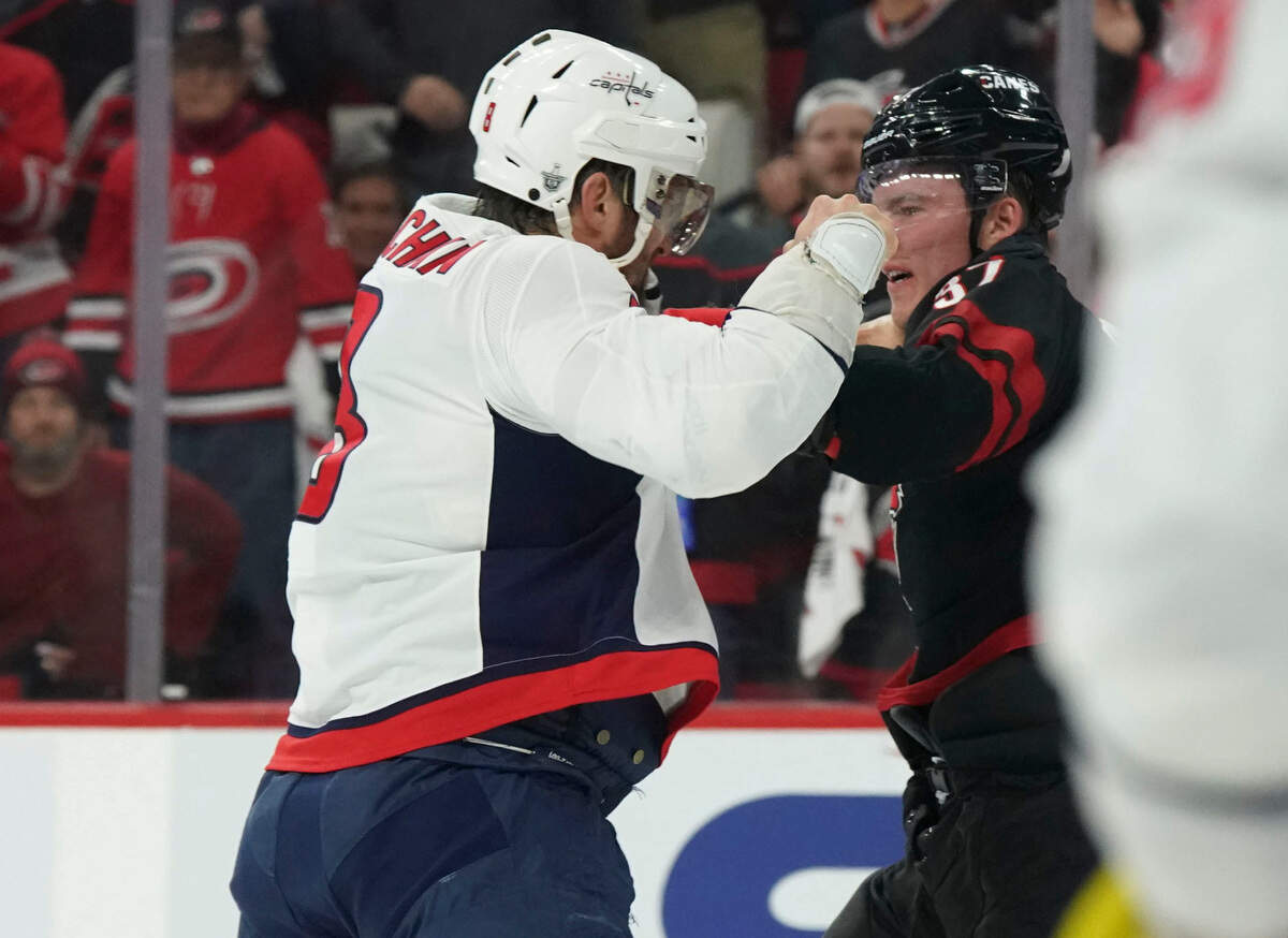 Washington Capitals left wing Alex Ovechkin (8) fights Carolina Hurricanes right wing Andrei Svechnikov (37) during the first period in game three of the first round of the 2019 Stanley Cup Playoffs at PNC Arena.