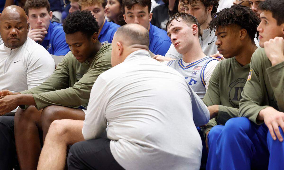 Duke head basketball trainer Jose Fonseca works on Cooper Flagg’s legs after he cramped up during the second half of Duke’s 100-58 victory over Army at Cameron Indoor Stadium in Durham, N.C., Friday, Nov. 8, 2024.
