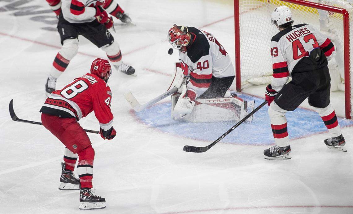 New Jersey Devils goalie Akira Schmid (40) stops a scoring attempt in overtime by the Carolina Hurricanes Jordan Martinook (48) in overtime during Game 5 of their second round Stanley Cup playoff series on Thursday, May 11, 2023 at PNC Arena in Raleigh, N.C. Schmid made 36 saves in the 3-2 loss.