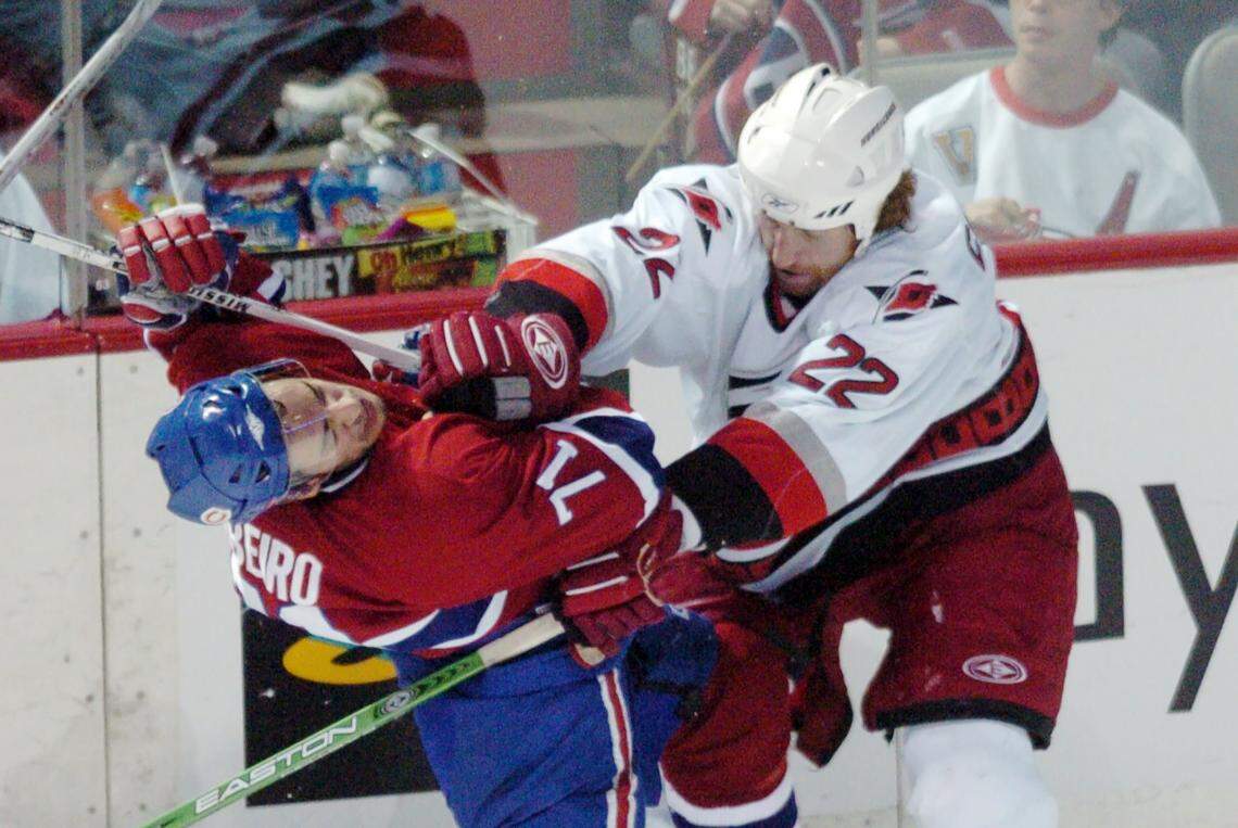 Mike Commodore (22) lays a check on Montreal’s Mike Ribeiro (71) during Game 4 of an NHL playoff game between the Carolina Hurricanes and the Montreal Canadiens.