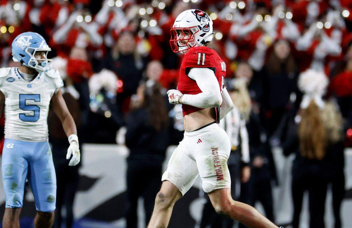 N.C. State linebacker Payton Wilson (11) smiles as he heads to the sidelines after intercepting a pass during the second half of N.C. State’s 39-20 victory over UNC at Carter-Finley Stadium in Raleigh, N.C., Saturday, Nov. 25, 2023.