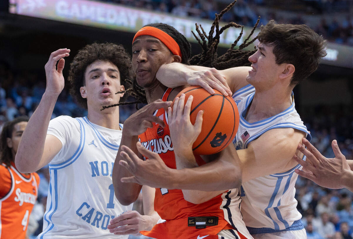North Carolina’s Cormac Ryan (3) battles for a rebound with Syracuse’s Maliq Brown(1) in the first half on Saturday, January 13, 204 at the Smith Center in Chapel Hill, N.C.