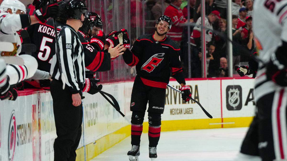 Feb 19, 2024; Raleigh, North Carolina, USA; Carolina Hurricanes center Jesperi Kotkaniemi (82) celebrates his goal against the Chicago Blackhawks during the second period at PNC Arena. Mandatory Credit: James Guillory-USA TODAY Sports
