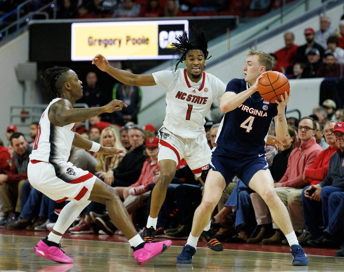 N.C. State’s DJ Horne and Jayden Taylor pressure Virginia’s Andrew Rohde during the first half of the Wolfpack’s 76-60 win on Saturday, Jan. 6, 2024, at PNC Arena in Raleigh, N.C.