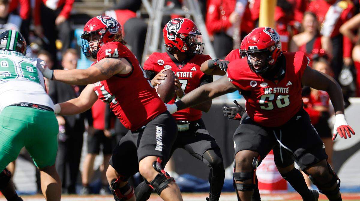 As his offensive line protects him, N.C. State quarterback MJ Morris (7) looks for a receiver during the first half of N.C. State’s game against Marshall at Carter-Finley Stadium in Raleigh, N.C., Saturday, Oct. 7, 2023.
