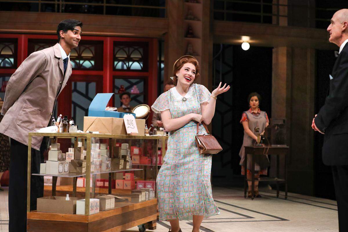 Michael Maliakel as Georg, Jenny Latimer as Amalia and Ray Dooley as Mr. Maraczek in “She Loves Me” at PlayMakers Repertory Company.  The Broadway musical adaptation popped up in 1963, and again in 1993 and 2016 revivals. The story was perhaps most famously reshuffled into the 1998 film “You’ve Got Mail” with Tom Hanks and Meg Ryan.  It runs through Dec. 9.