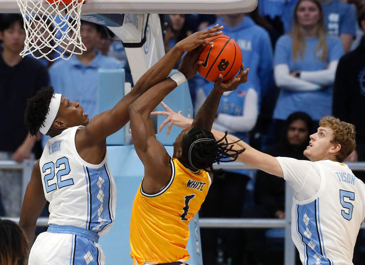 North Carolina’s Ven-Allen Lubin and Cade Tyson contest a shot by La Salle’s Jahlil White during the first half of the Tar Heels’ 93-67 win on Saturday, Dec. 14, 2024, at the Smith Center in Chapel Hill, N.C.