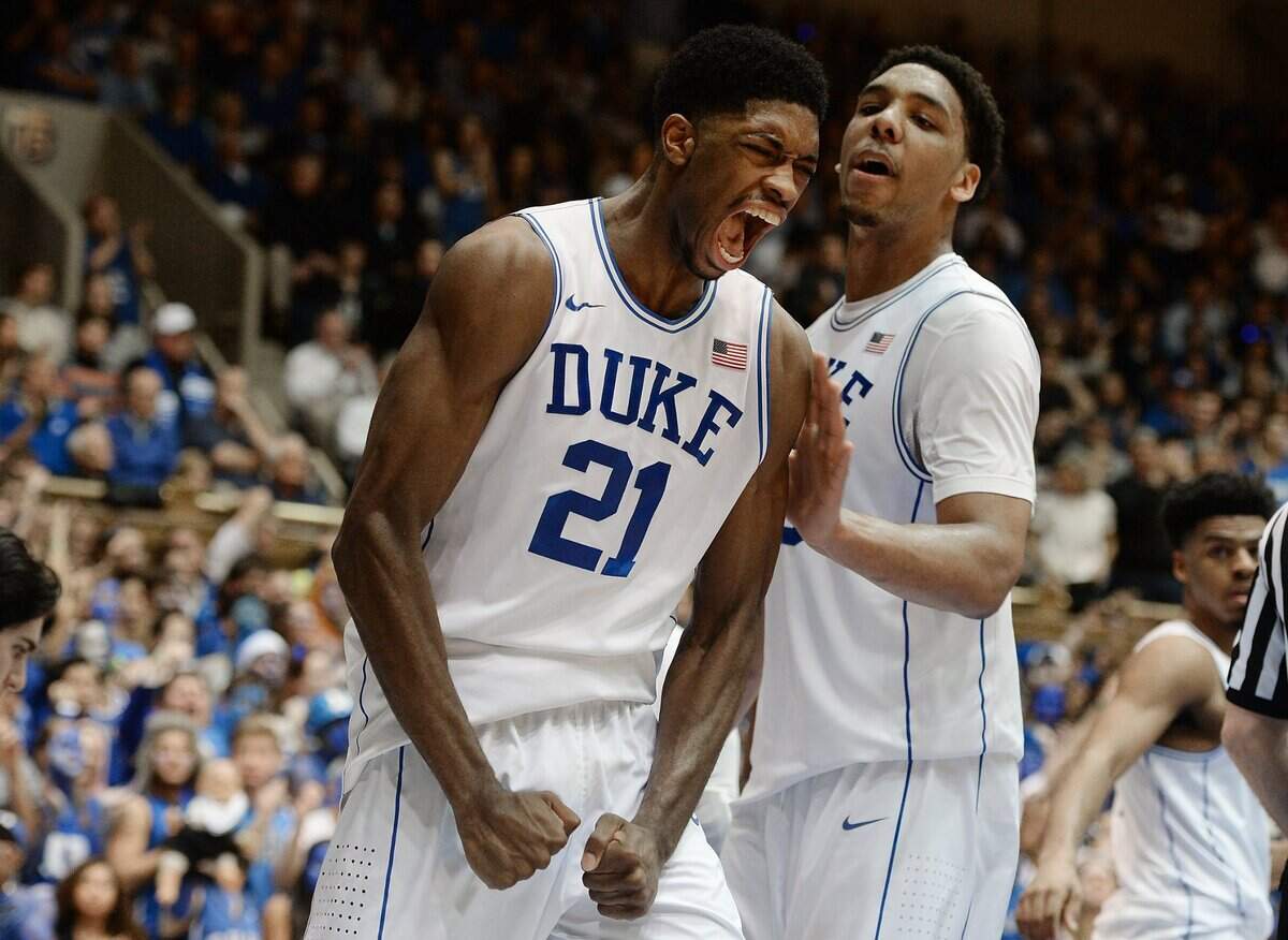 Duke forward Amile Jefferson (21) reacts after being fouled and making the shot in the second half of play as teammate Duke center Jahlil Okafor (15) looks on. Duke beat North Carolina 92-90 in overtime in Durham, NC Wednesday, Feb. 18, 2015.