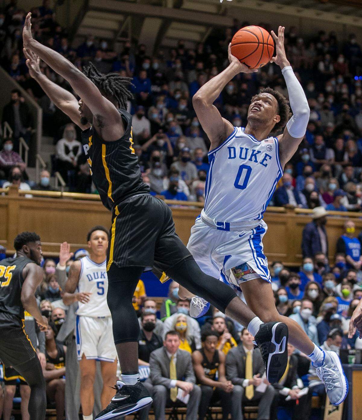 Duke’s Wendell Moore Jr. (0) puts up a shot against Appalachian State’s Adrian Delph (20) in the first half on Wednesday, Thursday 16, 2021 at Cameron Indoor Stadium in Durham, N.C. Moore Jr. lead all scores with 21 points in the Blue Devils’ 92-67 victory.
