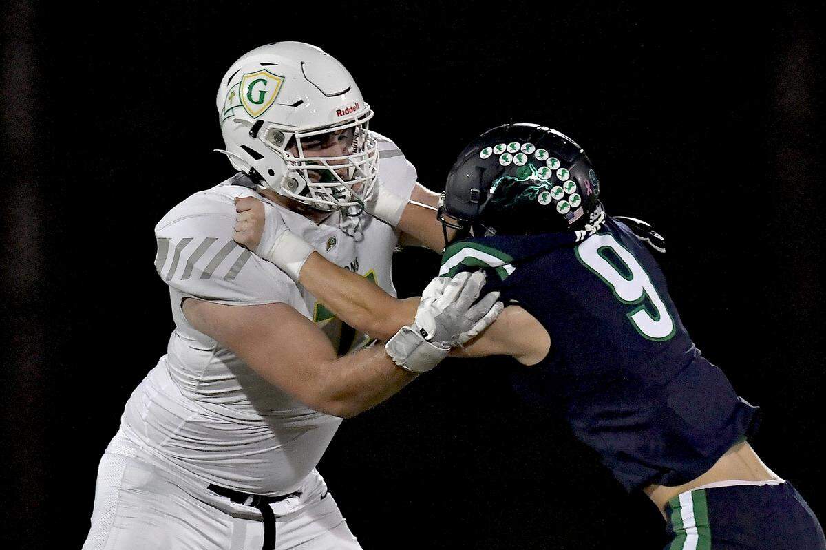 Cardinal Gibbons offensive tackle Jack Sheehan (71) and Leesville Road defensive lineman Sam White (9) grapple on the line of scrimmage during the first half. The Leesville Road Pride and the Cardinal Gibbons Crusaders met in a conference football game in Raleigh, N.C. on November 1, 2024.