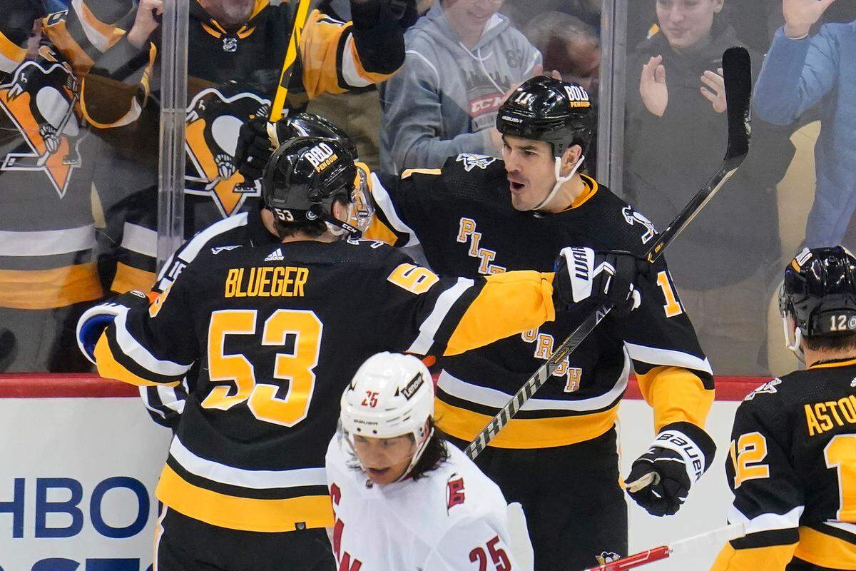 Pittsburgh Penguins’ Brian Boyle (11) celebrates with Teddy Blueger (53) after scoring during the first period of an NHL hockey game against the Carolina Hurricanes in Pittsburgh, Sunday, March 13, 2022. (AP Photo/Gene J. Puskar)