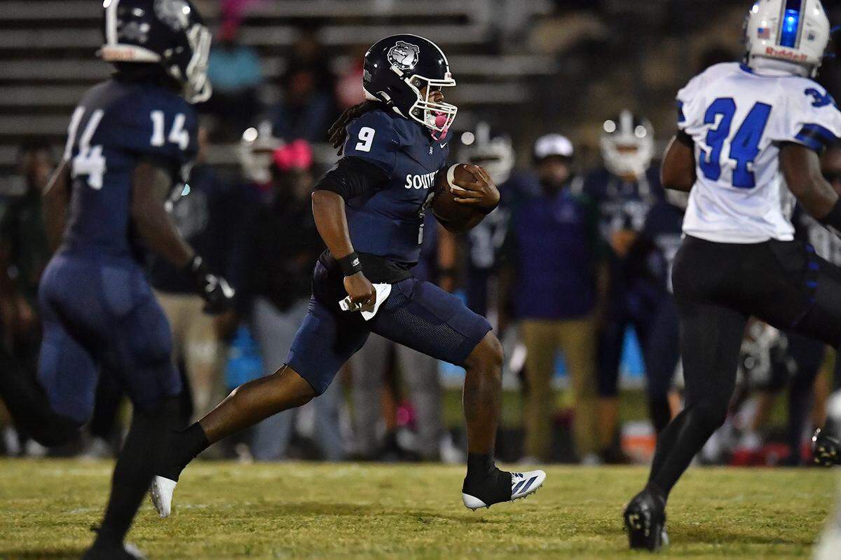 Southeast Raleigh quarterback James McCullers (9) runs for the first down against Clayton during the first half. The Southeast Raleigh Bulldogs and the Clayton Comets met in a non-conference football game in Raleigh, N.C. October 3, 2025