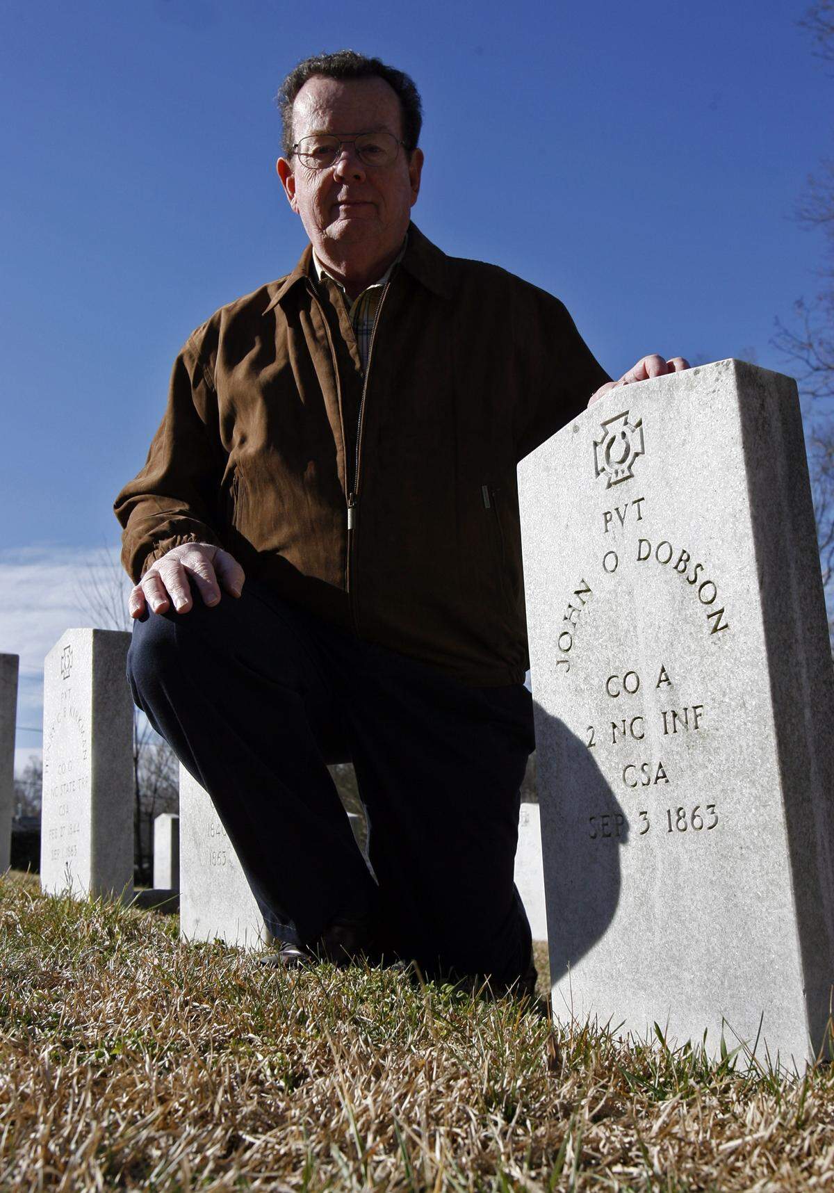 Civil War history buff Charles Purser, photographed in 2007, shows a headstone where a Union soldier is buried, even though the marker indicates a confederate soldier, John O. Dobson is there.  The actual person is John O. Dolson, and his monument has been replaced.