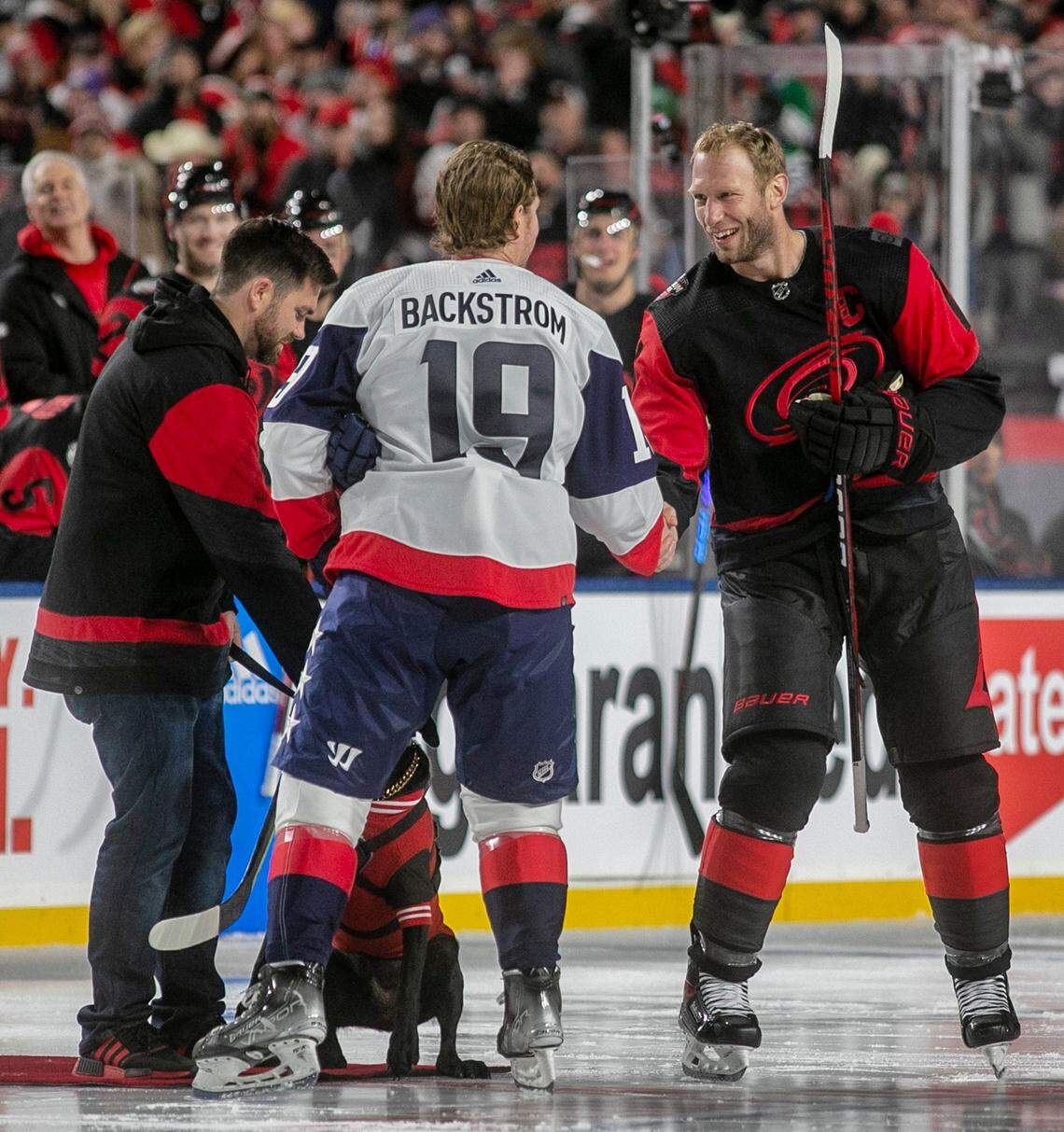 Carolina Hurricanes’ Jordan Staal (10) shakes hands with Washington Capitals’ Nicklas Backstroke (19) following the ceremonial puck drop, prior the Stadium Series game on Saturday, February 18, 2022 at Carter-Finley Stadium in Raleigh, N.C.