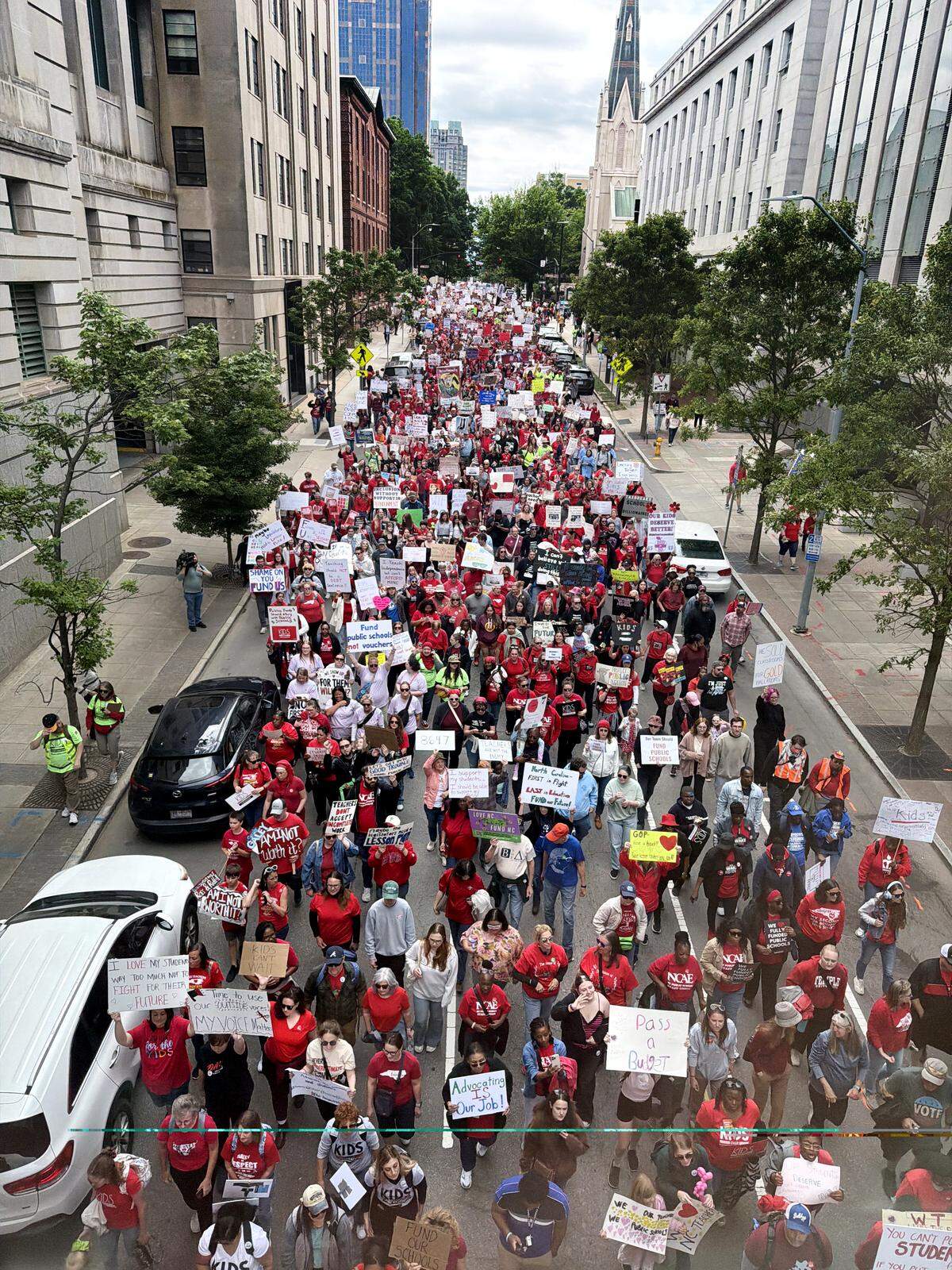 Protesters march through downtown Raleigh during a May Day rally for teachers and education, Friday, May 1, 2026.
