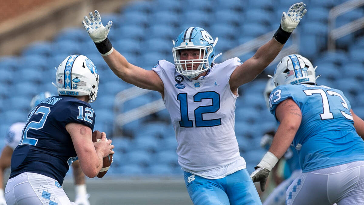 North Carolina defensive lineman Beau Atkinson (12) pressures quarterback Tad Hudson (12) during the Tar Heels’ spring football game on Saturday, April 15, 2023 at Kenan Stadium in Chapel Hill, N.C.
