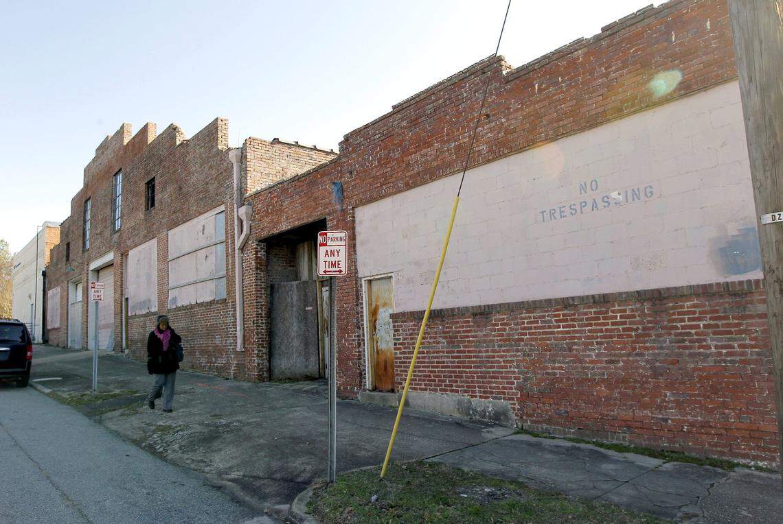 Just blocks away from the newer, taller buildings, Stones Warehouse is all boarded shut in downtown Raleigh on Dec. 11, 2014. The city bought southeast Raleigh property intending to bring affordable housing to E. Davie St. Now they’re heading in the opposite direction, looking at offers from private developers.