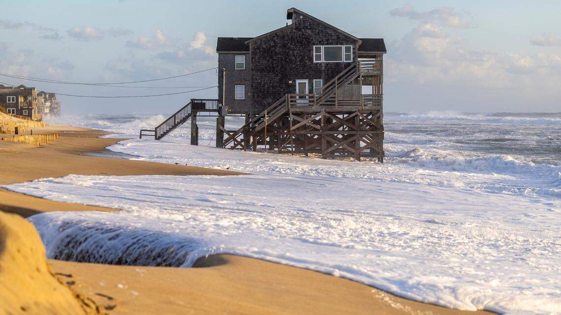 A home sits in the surf in Rodanthe Friday, Sept, 15, 2023 as Hurricane Lee churns in the Atlantic hundreds of miles offshore.