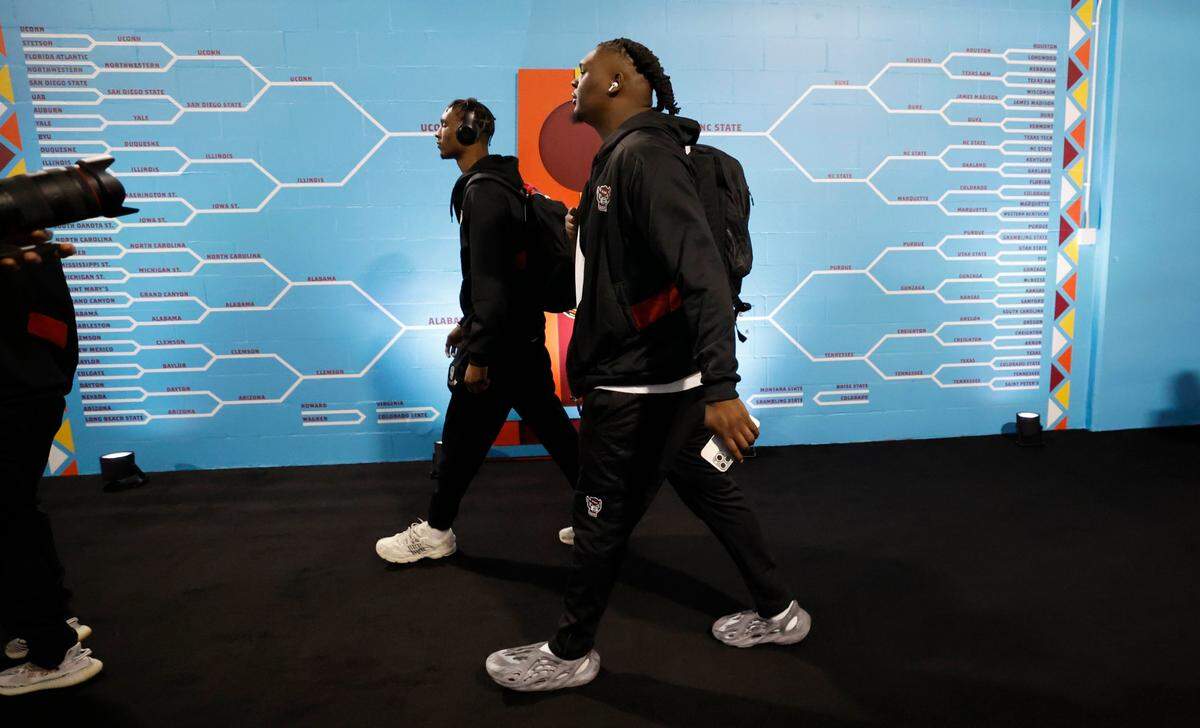 N.C. State’s Ernest Ross, left, and DJ Burns Jr. head to the locker room before the Wolfpack’s game against Purdue in the NCAA Tournament national semfinals at State Farm Stadium in Glendale, Ariz., Saturday, April 6, 2024.