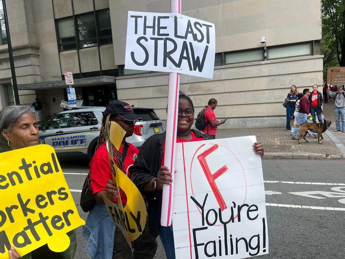 Third grade math teacher Nandi Dail came up from Charlotte to protest for higher teacher pay in downtown Raleigh Friday. Dail said she knows teachers moving back in with their parents because they can't afford to live in Charlotte anymore.