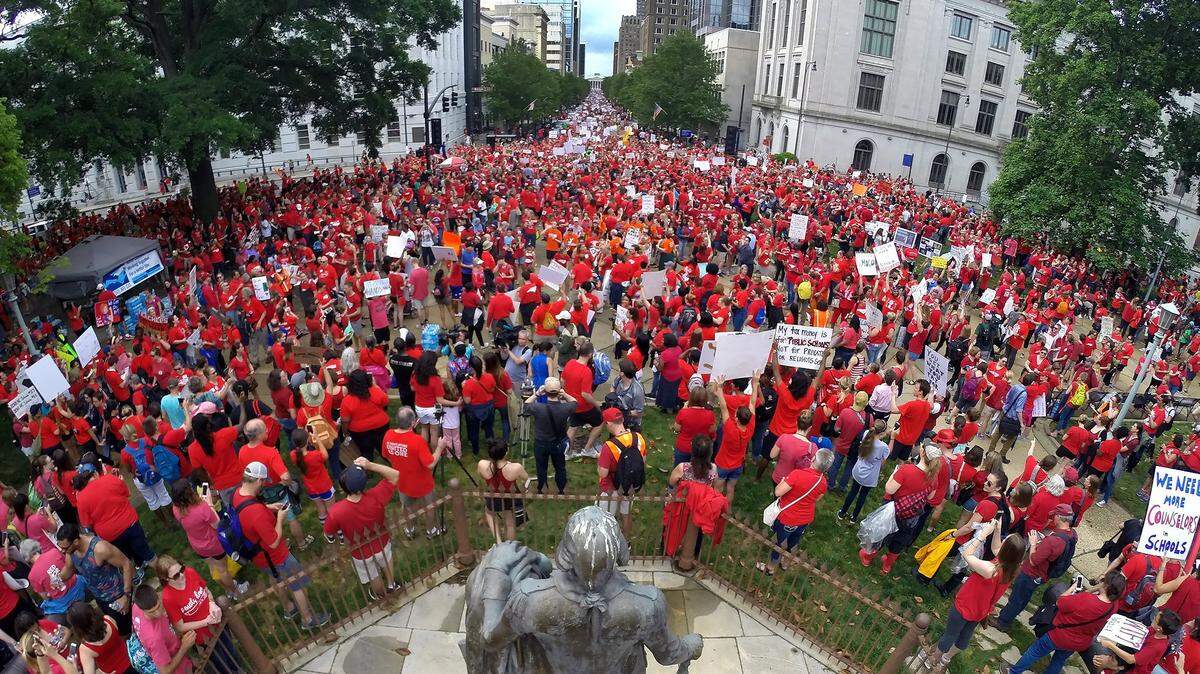 Thousands of teachers crowd Fayetteville Street as it dead ends into the N.C. State Capitol building in Raleigh, N.C. Wednesday, May 16, 2018 as they march to the N.C. Legislative building during the  “March for Students and Rally for Respect,” the largest act of organized teacher political action in state history.