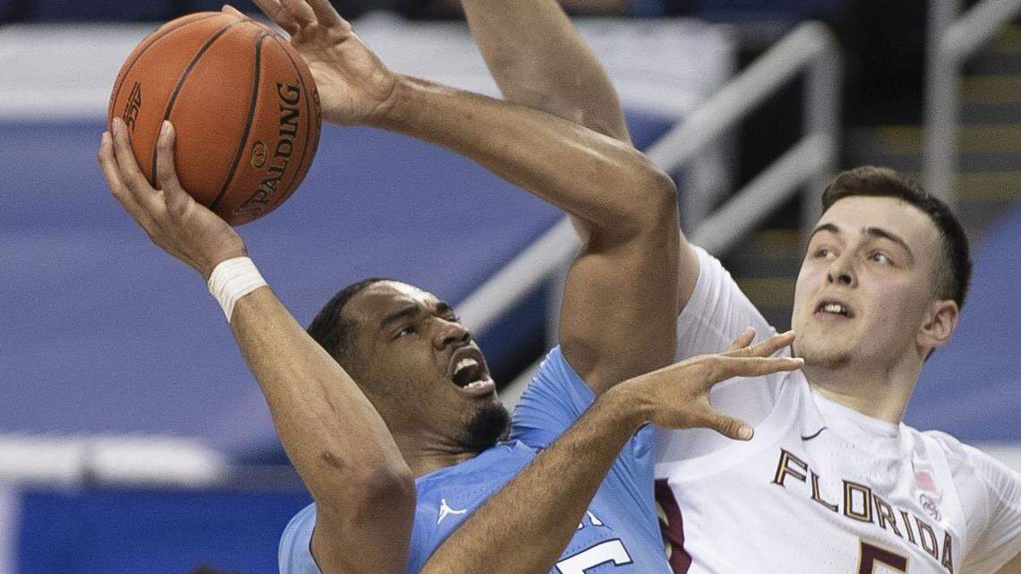 North Carolinas Garrison Brooks (15) drives to the basket against Florida States Balsa Koprivica (5) during the second half on Friday, March 12, 2021 in the semi-finals of the ACC Tournament at the Greensboro Coliseum in Greensboro, N.C.