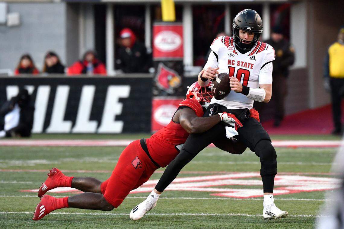 North Carolina State quarterback Ben Finley (10) is brought down by Louisville linebacker Yasir Abdullah (22) during the first half of an NCAA college football game in Louisville, Ky., Saturday, Nov. 19, 2022.