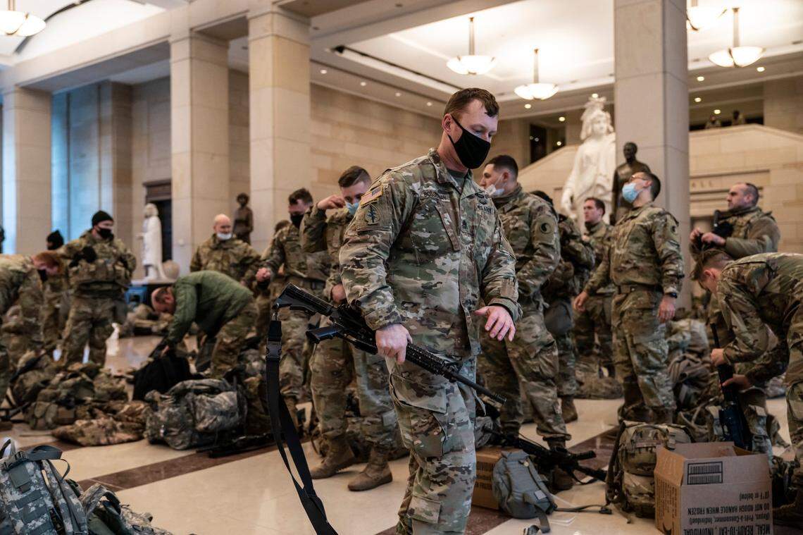 Hundreds of National Guard troops hold inside the Capitol Visitor’s Center to reinforce security at the Capitol in Washington, Wednesday, Jan. 13, 2021. The House of Representatives is pursuing an article of impeachment against President Donald Trump for his role in inciting an angry mob to storm the Capitol last week.