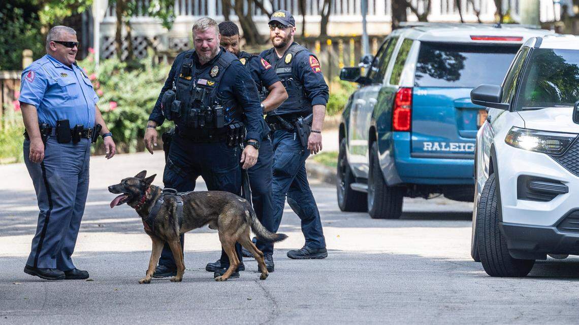 With the use of a bomb-sniffing dog, Raleigh Police, using a bomb-sniffing dog, work the scene of a bomb threat in Raleigh Tuesday, Aug 22, 2023.