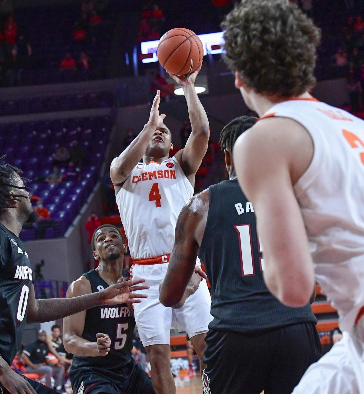 Clemson sophomore guard Nick Honor(4) makes a basket during overtime near NC State forward Manny Bates (15) during their game on January 5, 2021.
