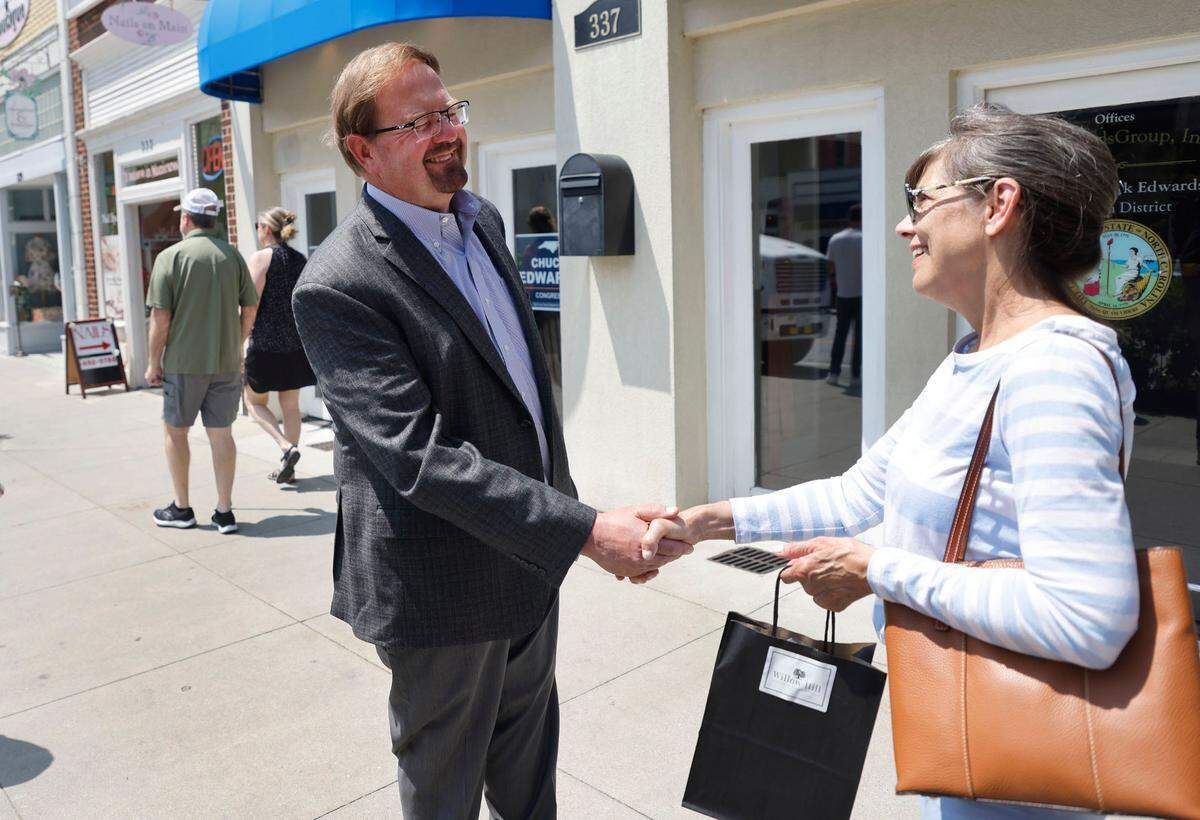 State Sen. Chuck Edwards talks with Denise Engle outside Edwards’ office in Hendersonville, N.C., Wednesday, May 18, 2022.