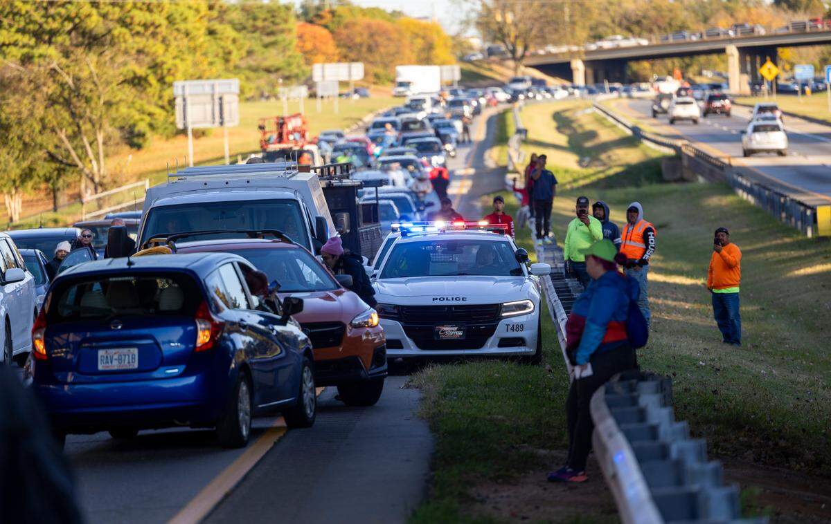 Motorists are stuck in traffic as protesters block the northbound lanes of the Durham Freeway at the South Magnum Street bridge for hours Thursday evening, Nov. 2, 2023 while demanding a ceasefire in the Israel-Gaza War as police warned of arrests.