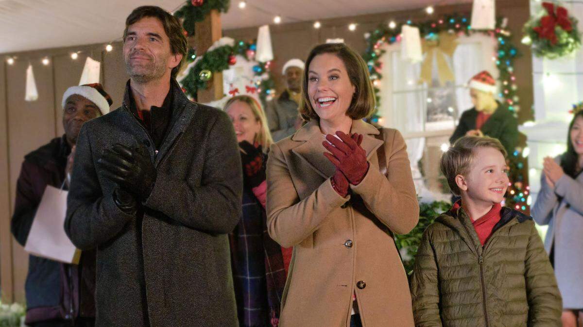 Lucas Bryant, Ashley Williams and Brady Droulis in the Hallmark Movies & Mysteries movie “Five More Minutes: Moments Like These,” based on the song “Five More Minutes” by Scotty McCreery.