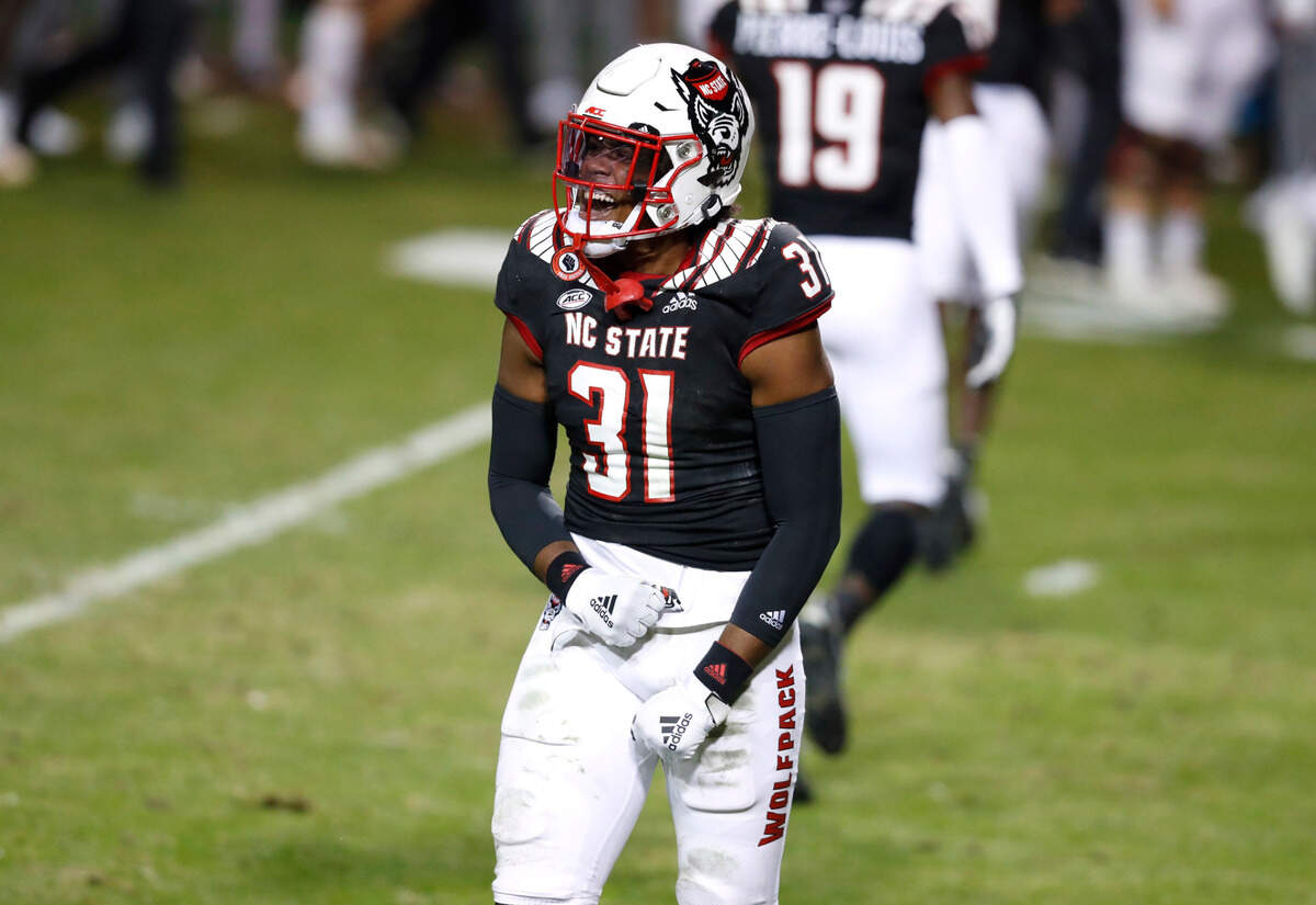N.C. State linebacker Vi Jones (31) celebrates after the Wolfpack forced Georgia Tech to turn the ball over on downs during the first half of N.C. State’s game against Georgia Tech at Carter-Finley Stadium in Raleigh, N.C., Saturday, Dec. 5, 2020.