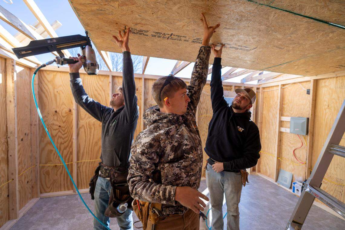 Volunteers install a ceiling into one of the temporary housing units they are building in Swannanoa, N.C. for those displaced by Hurricane Helene.
