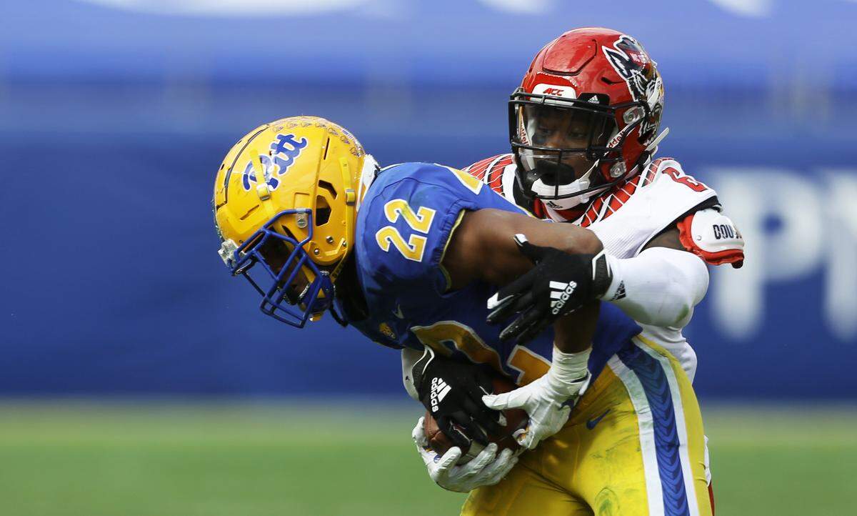 N.C. State’s Jakeen Harris (6) tackles Pittsburgh Panthers running back Vincent Davis (22) during the Wolfpack’s game against the Panthers at Heinz Field in Pittsburgh, PA, Saturday, Oct. 3, 2020.
