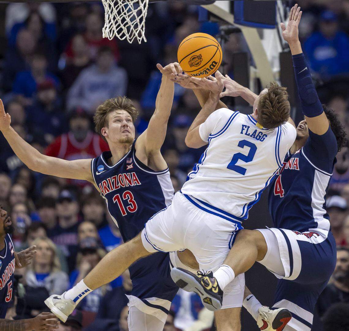 Arizona’s Trey Townsend (4) and Henri Veesaar (13) defend Duke forward Cooper Flagg (2) in the second half on Thursday, March 27, 2025 during the NCAA Sweet 16 at Prudential Center in Newark, NJ.