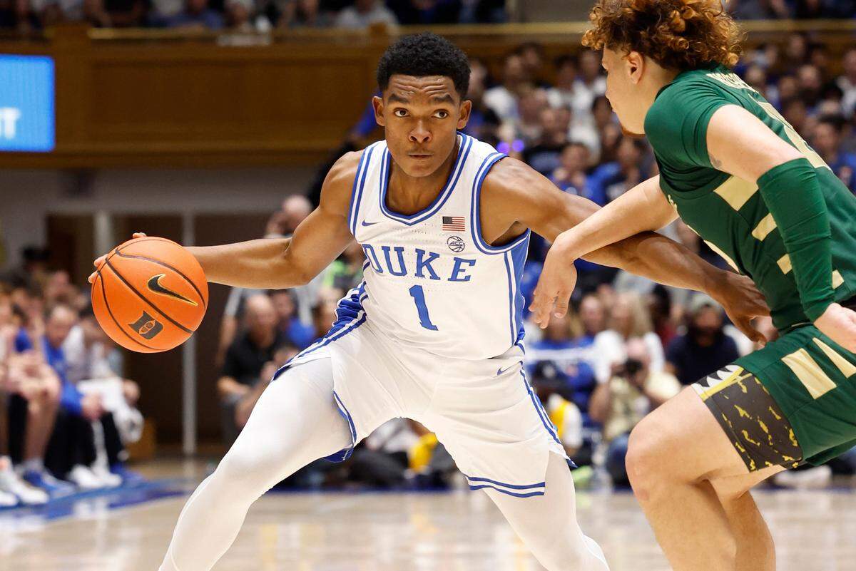 Duke’s Caleb Foster (1) drives by Charlotte’s Lu’Cye Patterson (25) during the first half of Duke’s game against Charlotte at Cameron Indoor Stadium in Durham, N.C., Saturday, Dec. 9, 2023.
