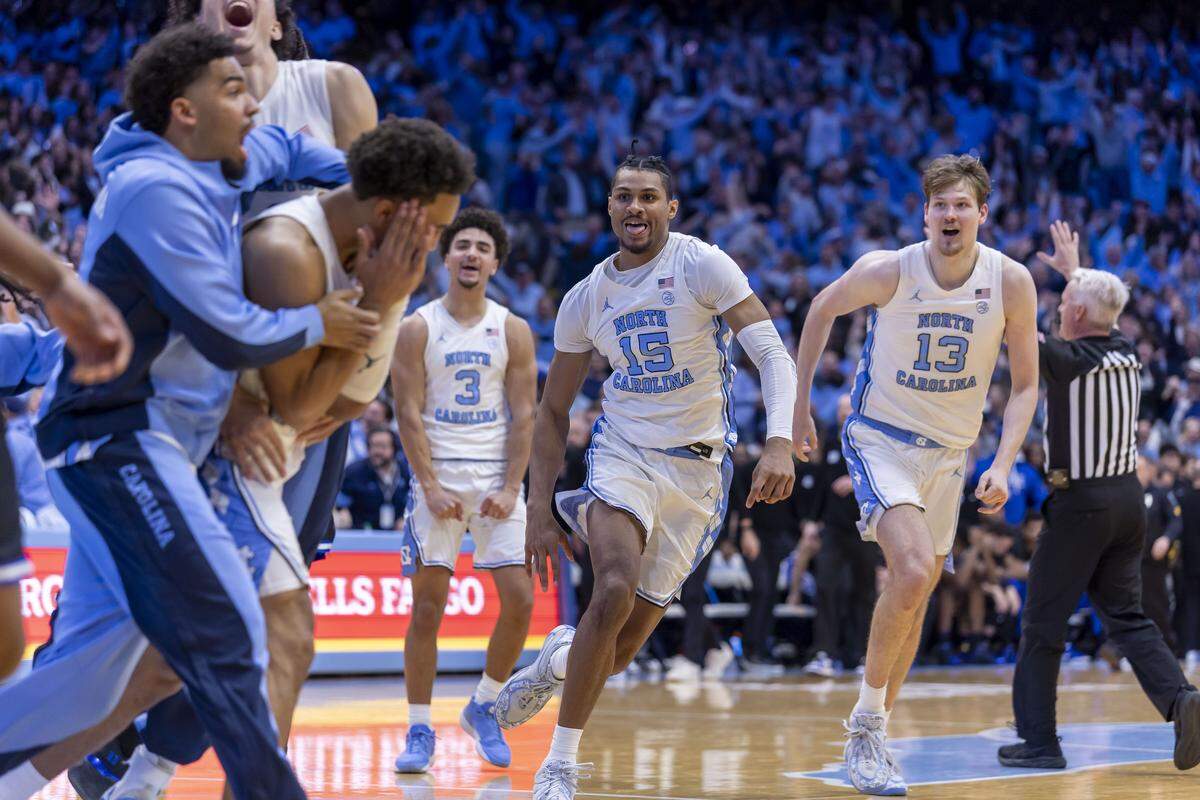 North Carolina forward Jarin Stevenson (15) and center Henri Veesaar (13) race toward teammate Seth Trimble after he sank the game winning shot with .4 seconds to play, giving the Tar Heels’ a 71-68 victory on Saturday, February 7, 2026 at the Smith Center in Chapel Hill, N.C.