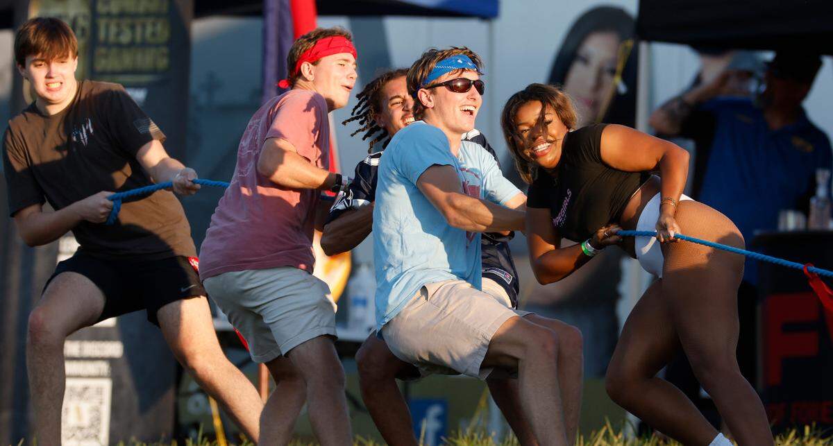 Attendees participate in a tug of war during “Flagstock 2024,” an invite-only concert featuring country musicians Big & Rich and Lee Greenwood, among others, at a location in Chapel Hill, N.C., Monday, Sept. 2, 2024. Flagstock started after a GoFundMe raised over $500,000 for a “rager” for UNC-Chapel Hill fraternity brothers who held up the American flag during an April campus protest.
