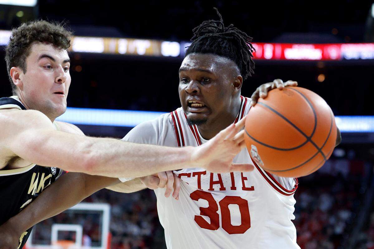 N.C. State’s D.J. Burns Jr. (30) keeps the ball from Wake Forest’s Matthew Marsh (33) during the second half of N.C. State’s game against Wake Forest at PNC Arena in Raleigh, N.C., Wednesday, Feb. 22, 2023.