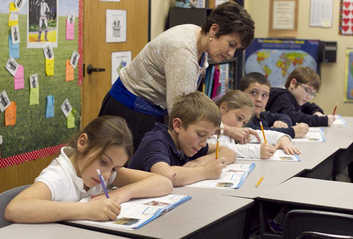 Teacher Cindy Kusilek works with students in her third-grade class at Franklin Academy Charter School on Feb. 22, 2013, in Wake Forest.