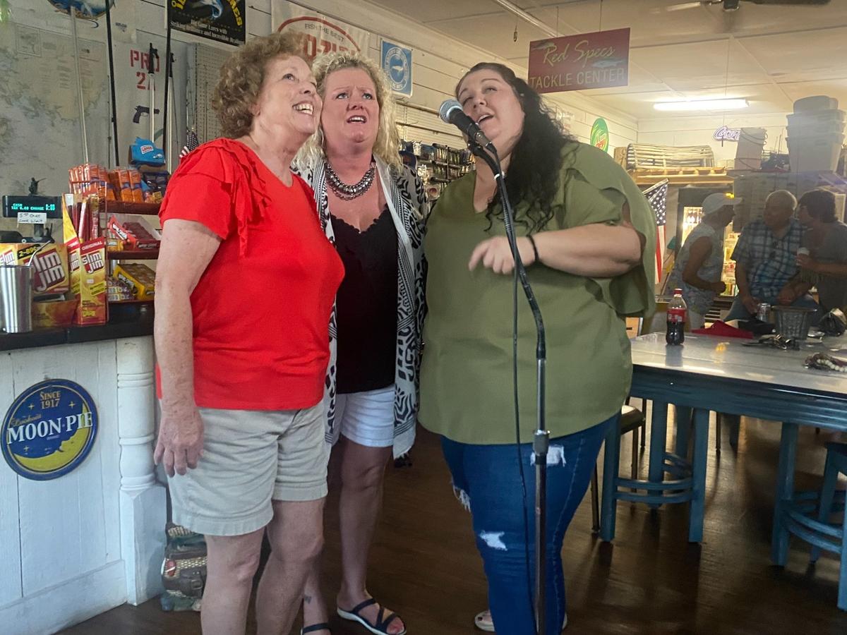 Lisa Caroom, Jamey Thomas and Jessica Milton perform as a karaoke trio at Squidders Bait & Tackle in Vandemere.