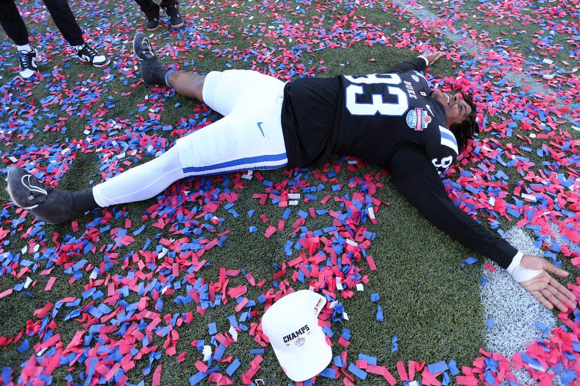 Duke Blue Devils defensive linemen Anthony Nelson (93) makes angels in the confetti after defeating the Troy Trojans at Protective Stadium on Saturday, Dec. 23, 2023.