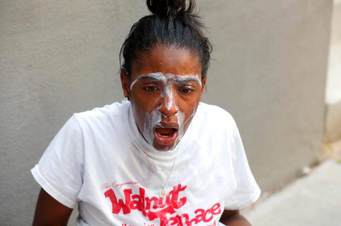 Jessica Peacock of Raleigh tries to get the tear gas out of her eyes during a protest in downtown Raleigh, N.C. Saturday, May 30, 2020.