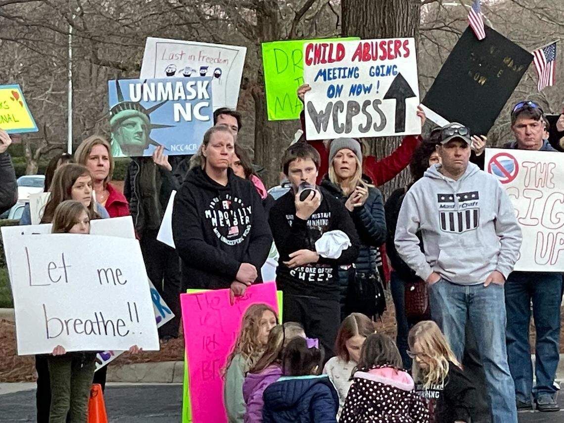A crowd rallies outside the Wake County school board meeting in Cary Tuesday, Feb. 15, 2022, demanding that the district immediately stop mandating that students wear masks.