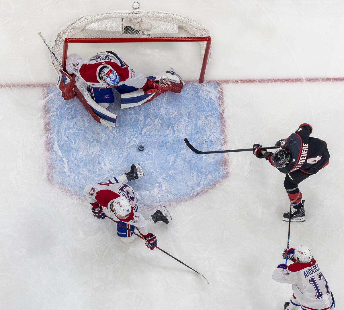 Carolina Hurricanes defenseman Shayne Gostisbehere (4) scores on Montreal goalie Jakub Dobes (75) in the second period during Game 5 of the Eastern Conference Finals against Montreal on Friday, May 29, 2026 at Lenovo Center in Raleigh, N.C.