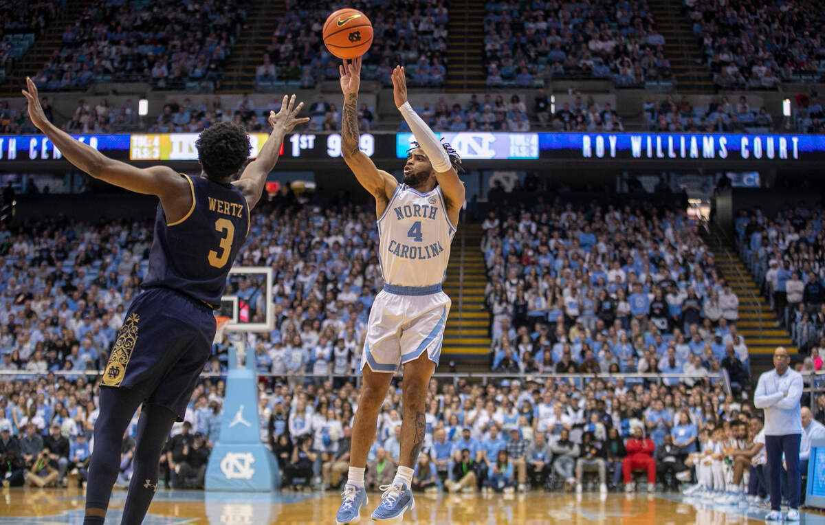 North Carolina’s R.J. Davis (4) launches a three point shot over Notre Dame’s Trey Wertz (3) in the first half on Saturday, January 7, 2023 at the Smith Center in Chapel Hill, N.C.