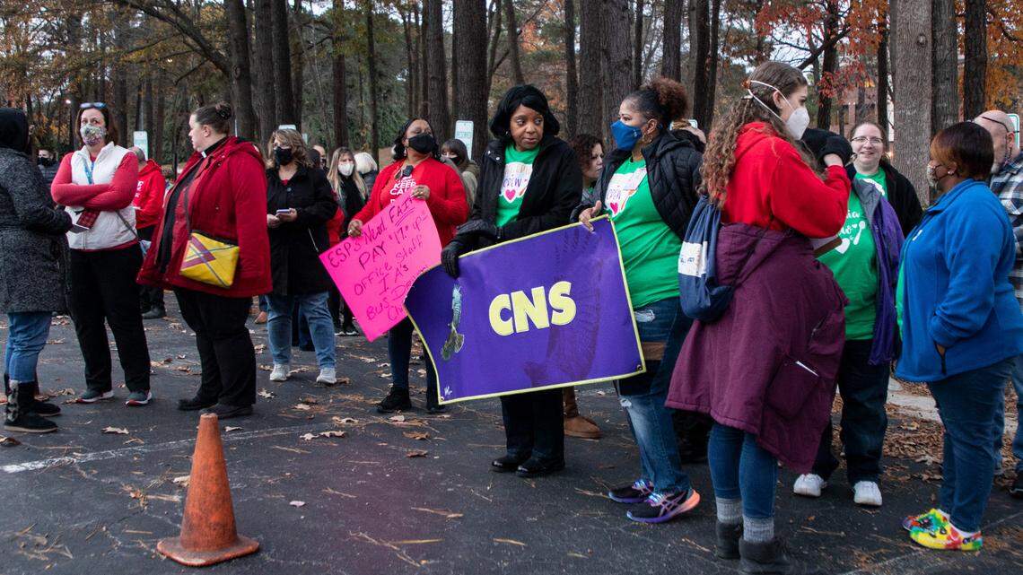 Educators, school support staff and their supporters rally outside the Wake County school board meeting in Cary, N.C. on Tuesday, Dec. 7, 2021 to call for higher pay. The school board is considering whether to ask for enough money to raise the minimum salary to $18 an hour for hourly staff.